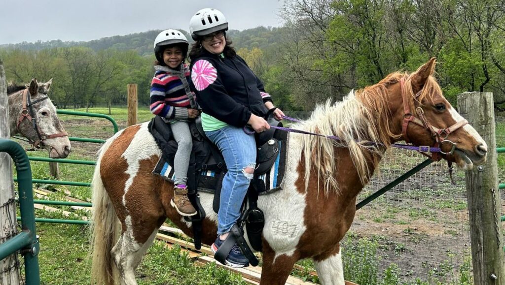 photo of parent and child riding horse at spring family camp