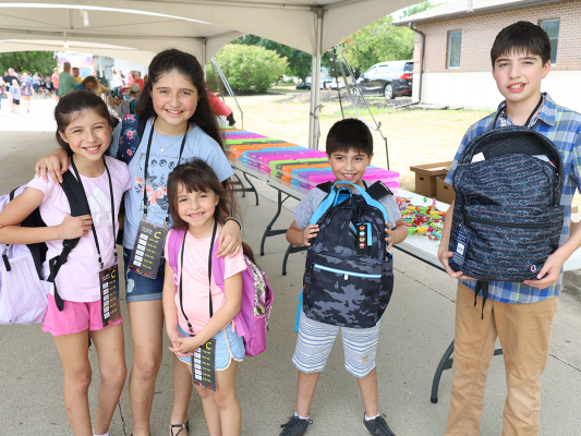 back to school family showing new backpacks